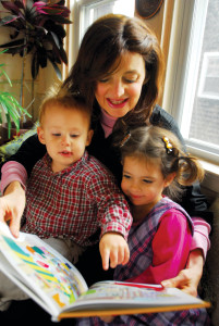 Bracha Goetz reads from one of her recent books to her two grandchildren Chaim Szendro, 1 and a half, and Tzippy, 3 and half.