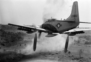 Flying low over the jungle, an A-1 Skyraider drops 500-pound bombs on a Viet Cong position below as smoke rises from a previous pass at the target, Dec. 26, 1964. (AP Photo/Horst Faas)